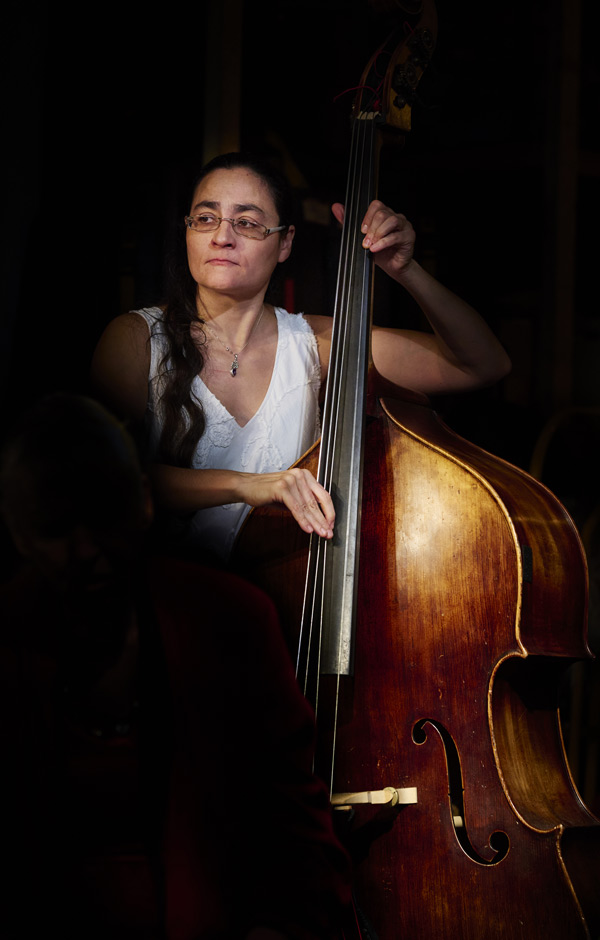 woman playing double bass in soft lighting live music performance